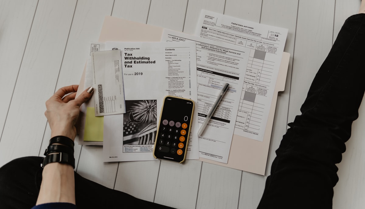 Woman reviewing financial documents and compensation packages at a desk